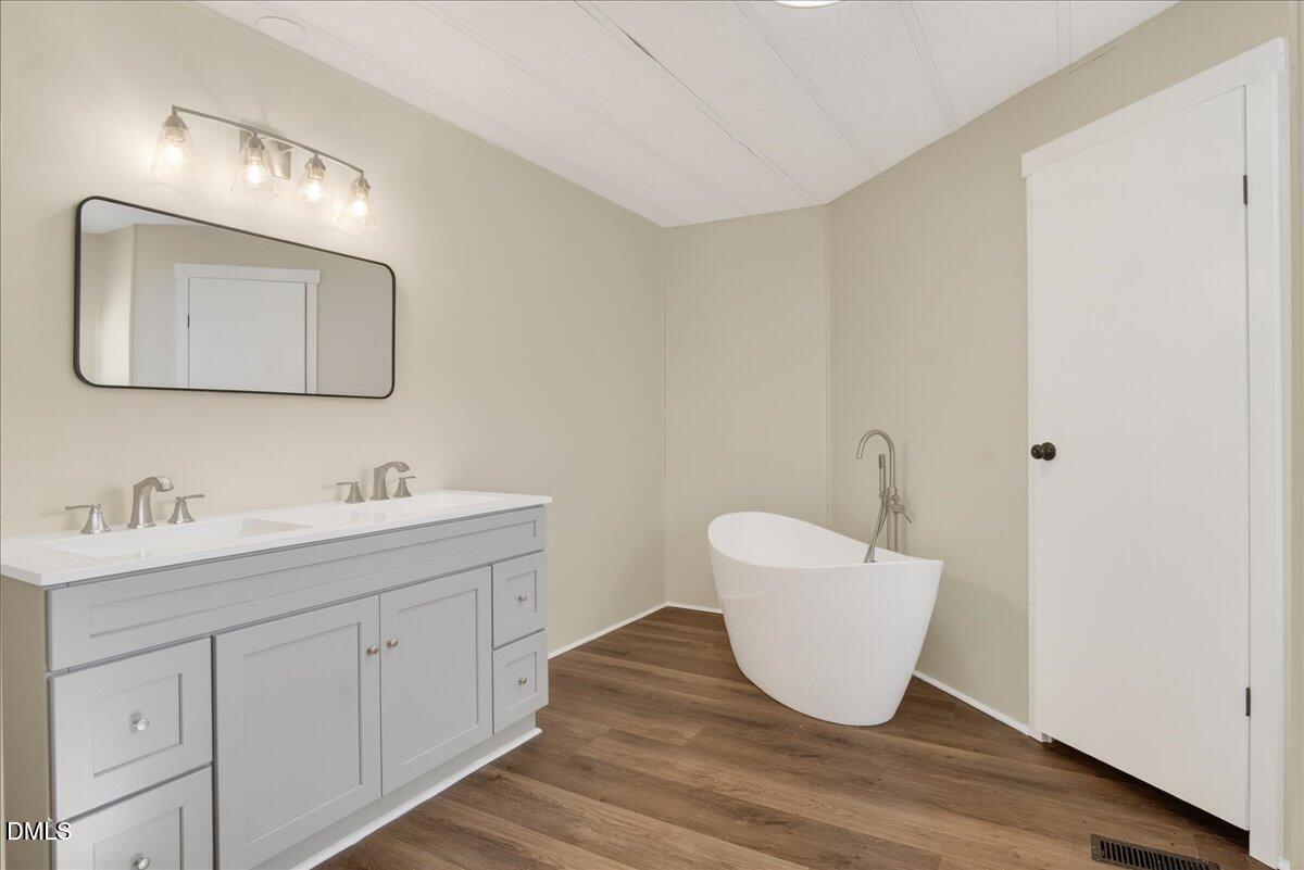 2428 Sims Bridge Road Kittrell, NC 27544 - Photo 25 of 57 a bathroom with a sink and a mirror