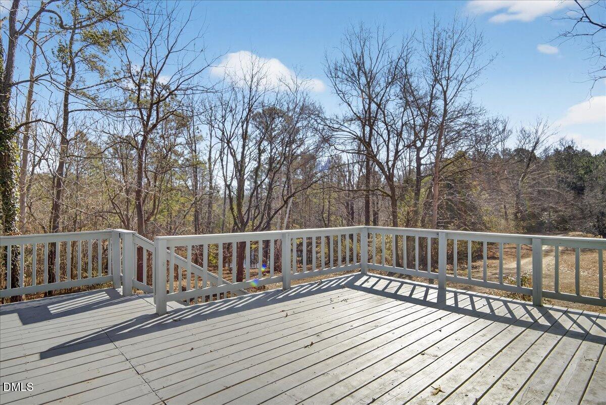 2428 Sims Bridge Road Kittrell, NC 27544 - Photo 37 of 57 a view of deck with trees and wooden floor
