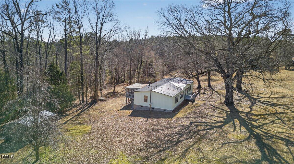 2428 Sims Bridge Road Kittrell, NC 27544 - Photo 55 of 57 a view of a backyard with wooden fence and large trees