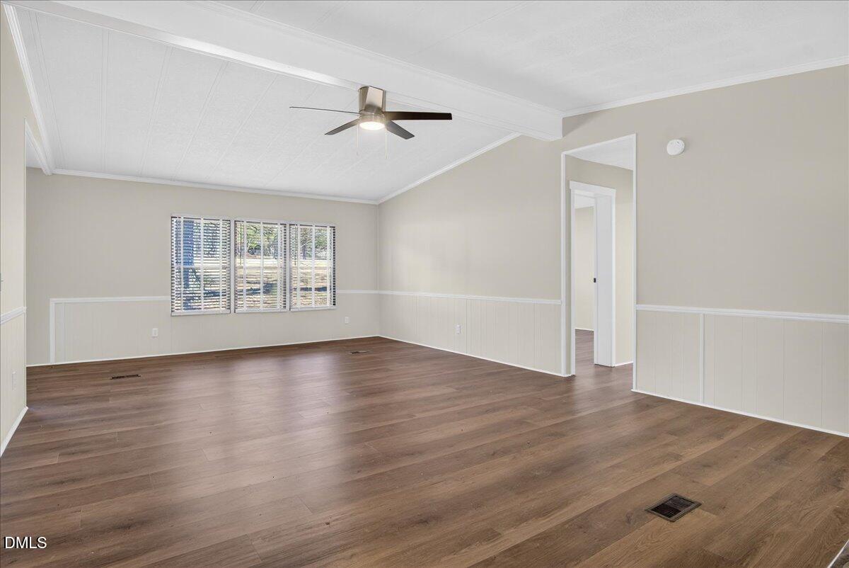 2428 Sims Bridge Road Kittrell, NC 27544 - Photo 9 of 57 an empty room with wooden floor fan and windows