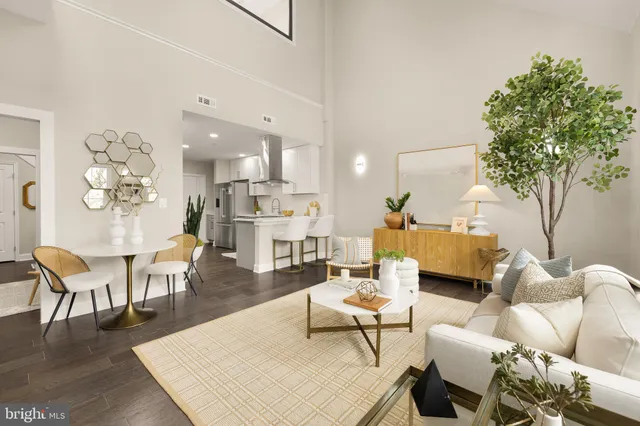 a living room with furniture a table and a potted plant
