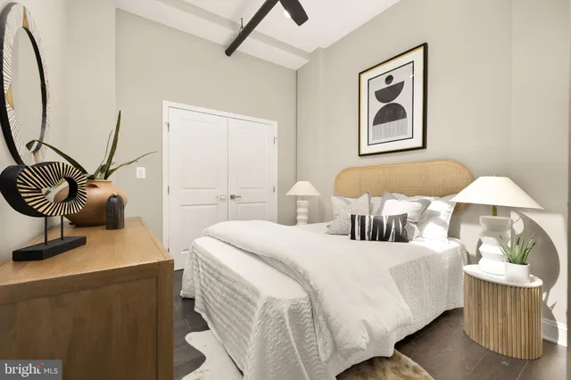 a bedroom with a bed and wooden floor