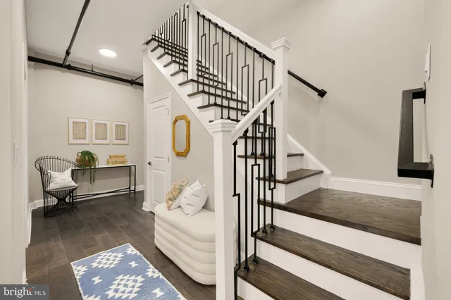 a living room with wooden floor and a table