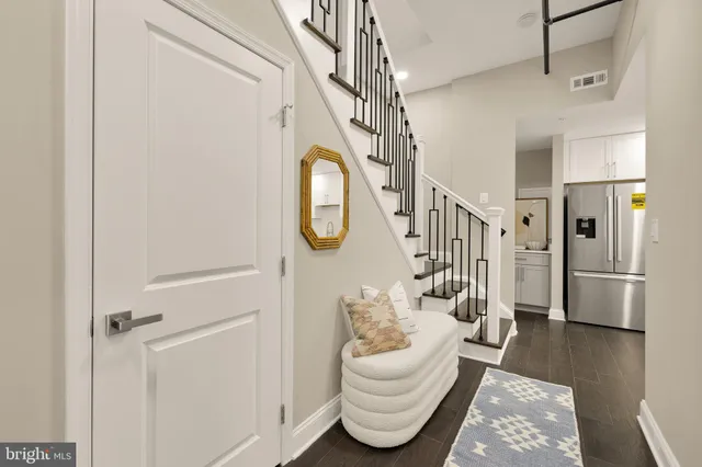 a living room with wooden floor furniture and a chandelier