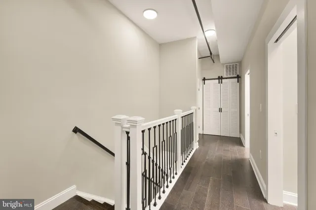 a view of hallway with wooden floor