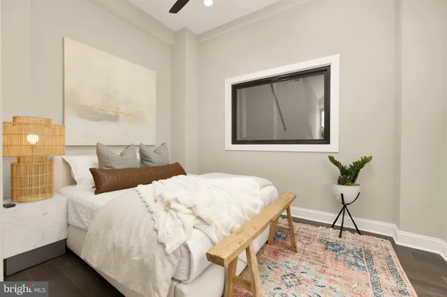 a bedroom with a bed and a painting on the wall