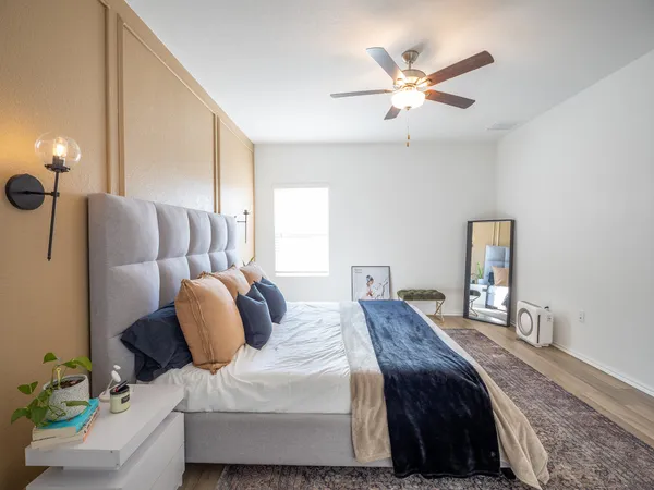 a bedroom with bed and window