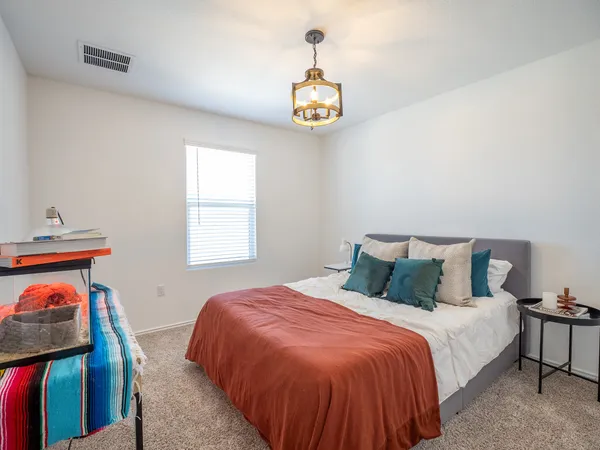 a bedroom with a bed and a window