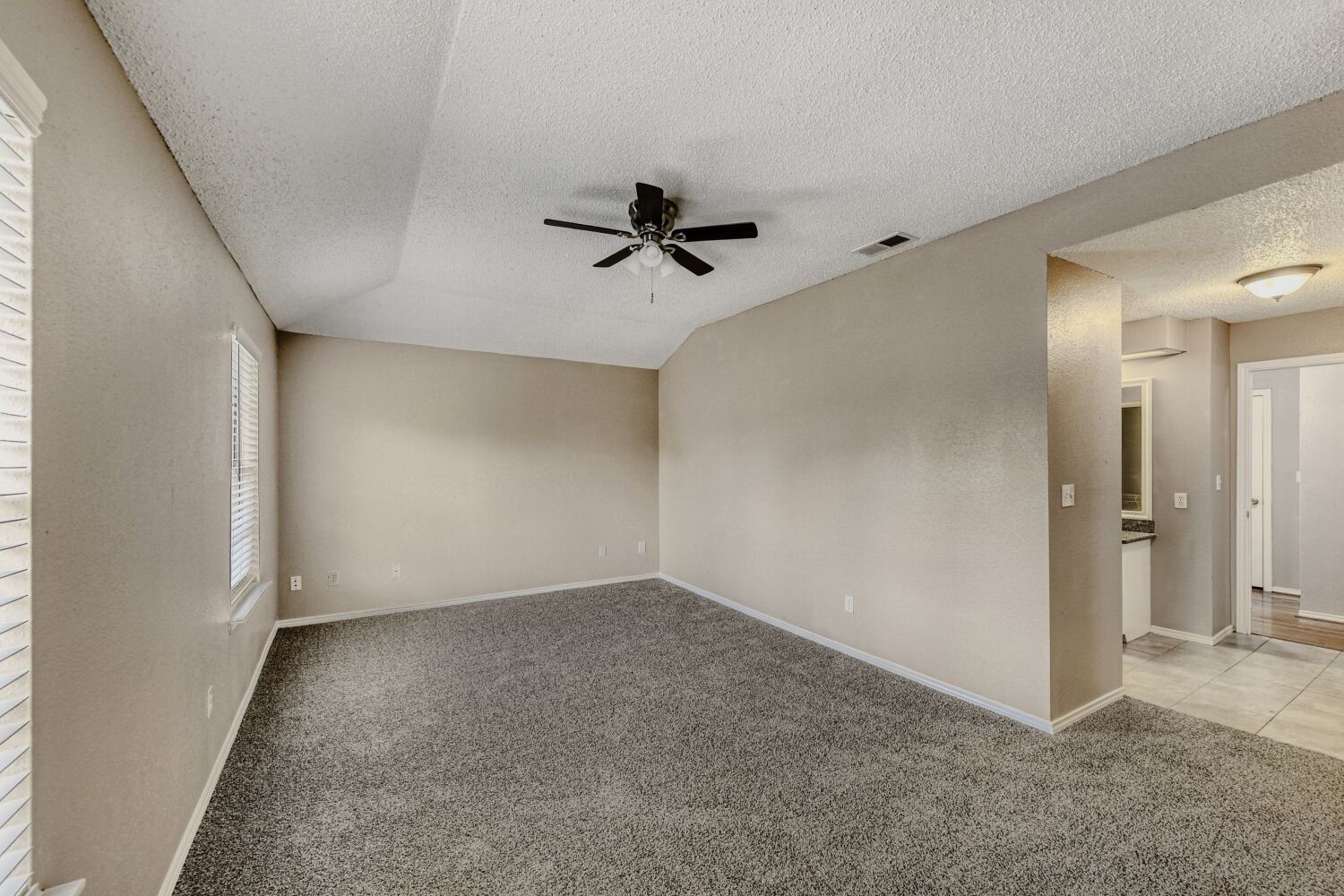 9727 Orangevale Drive Spring, TX 77379 - Photo 11 of 26 an empty room with a ceiling fan and carpet