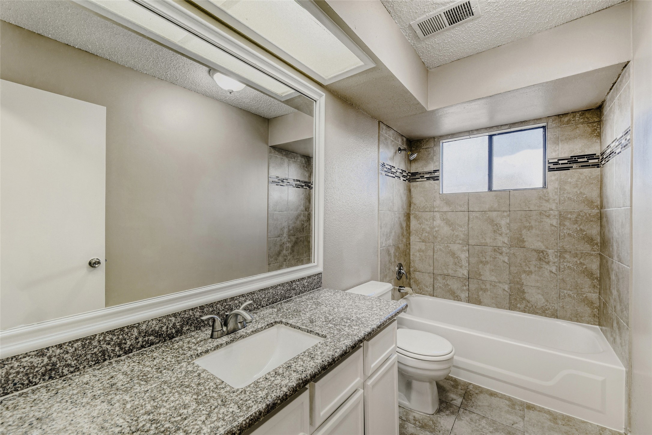 9727 Orangevale Drive Spring, TX 77379 - Photo 12 of 26 a bathroom with a granite countertop sink a toilet and shower