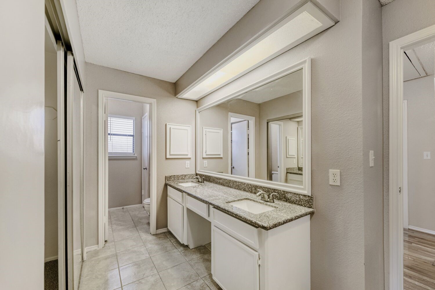 9727 Orangevale Drive Spring, TX 77379 - Photo 13 of 26 a bathroom with a granite countertop sink and a mirror