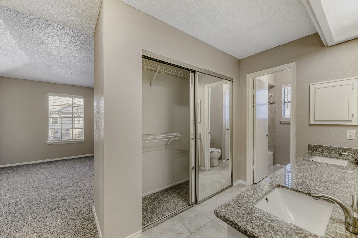 9727 Orangevale Drive Spring, TX 77379 - Photo 14 of 26 a bathroom with a granite countertop sink a mirror and a shower
