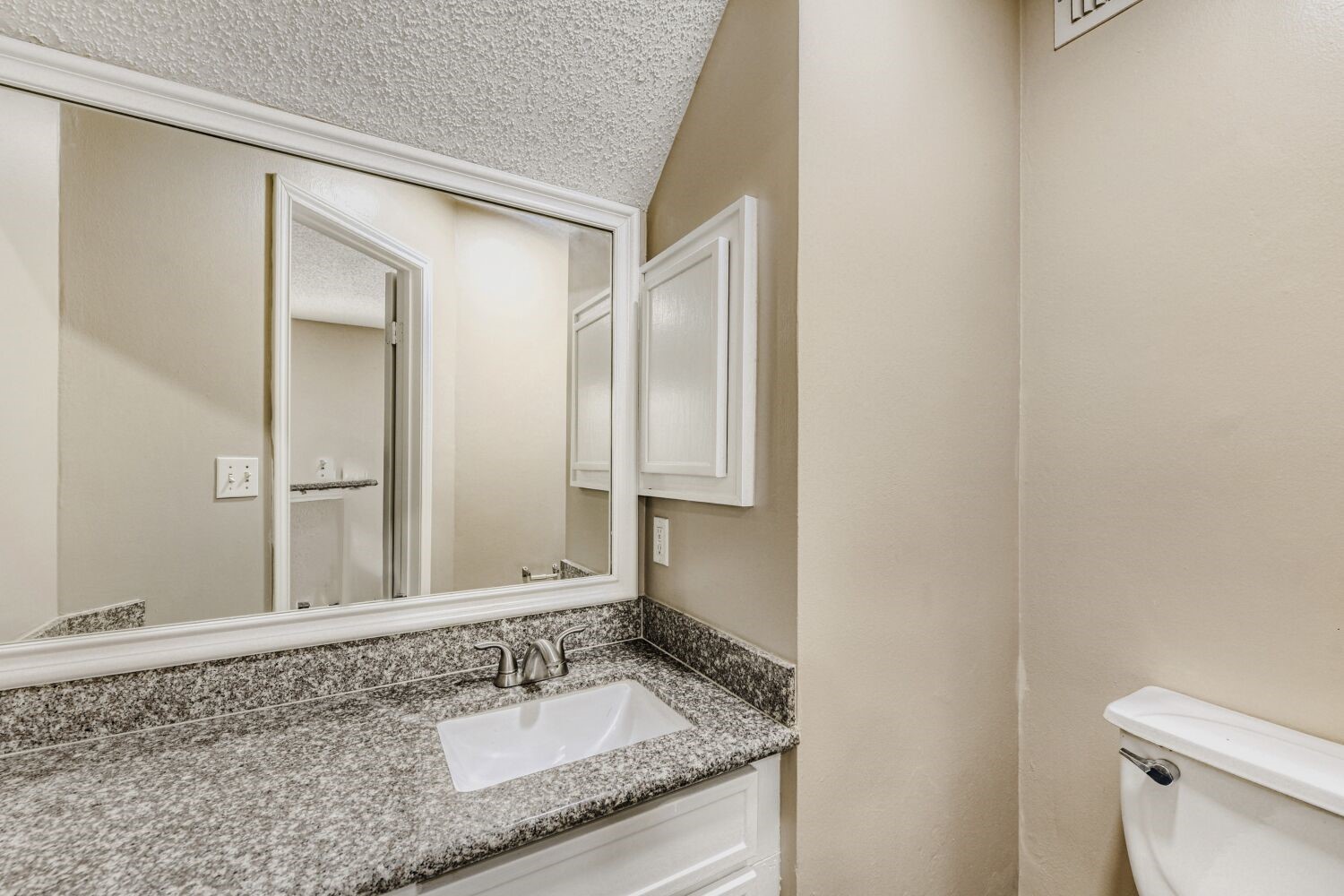 9727 Orangevale Drive Spring, TX 77379 - Photo 20 of 26 a bathroom with a granite countertop sink and a mirror