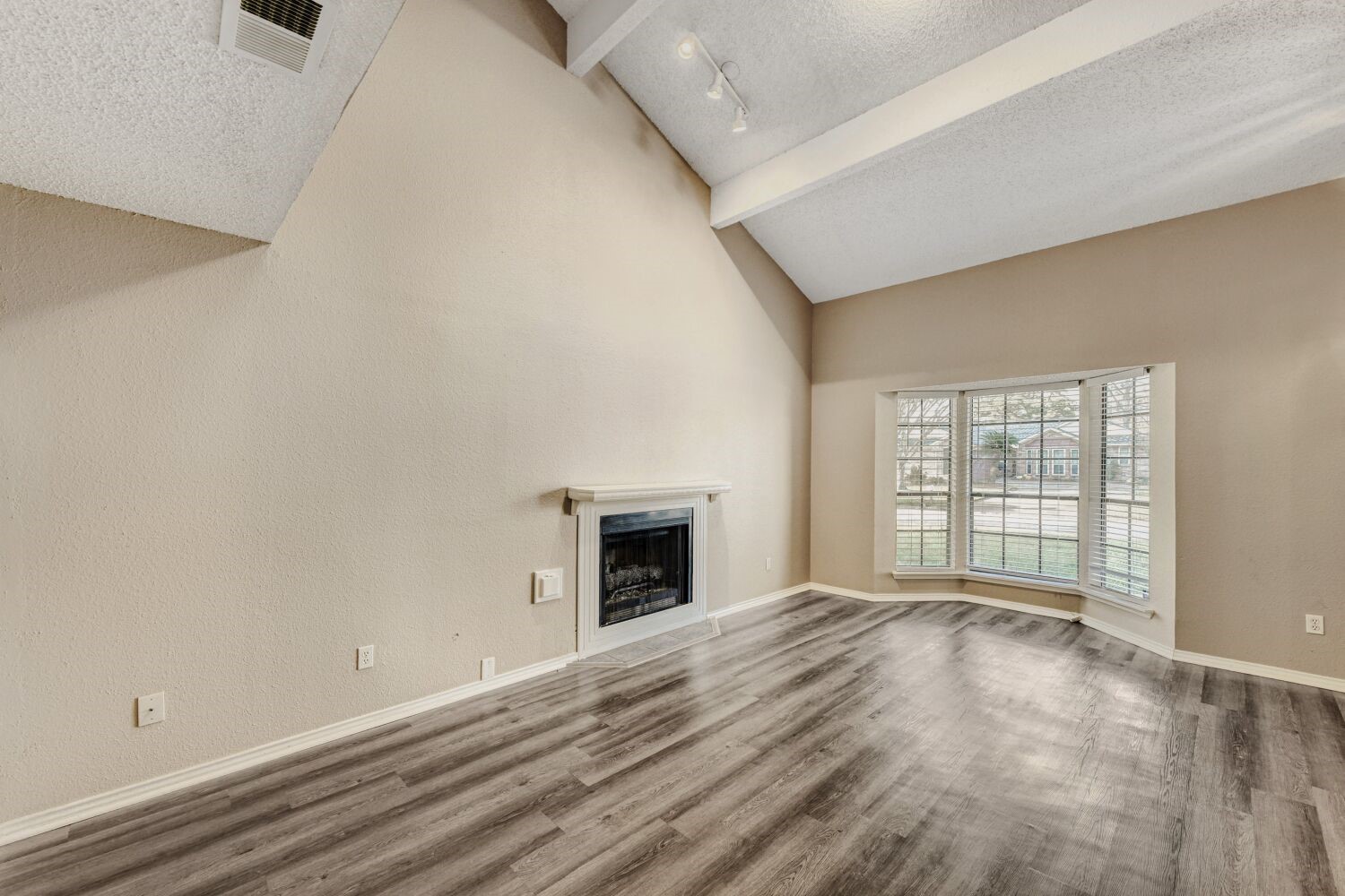 9727 Orangevale Drive Spring, TX 77379 - Photo 2 of 26 an empty room with wooden floor fireplace and windows