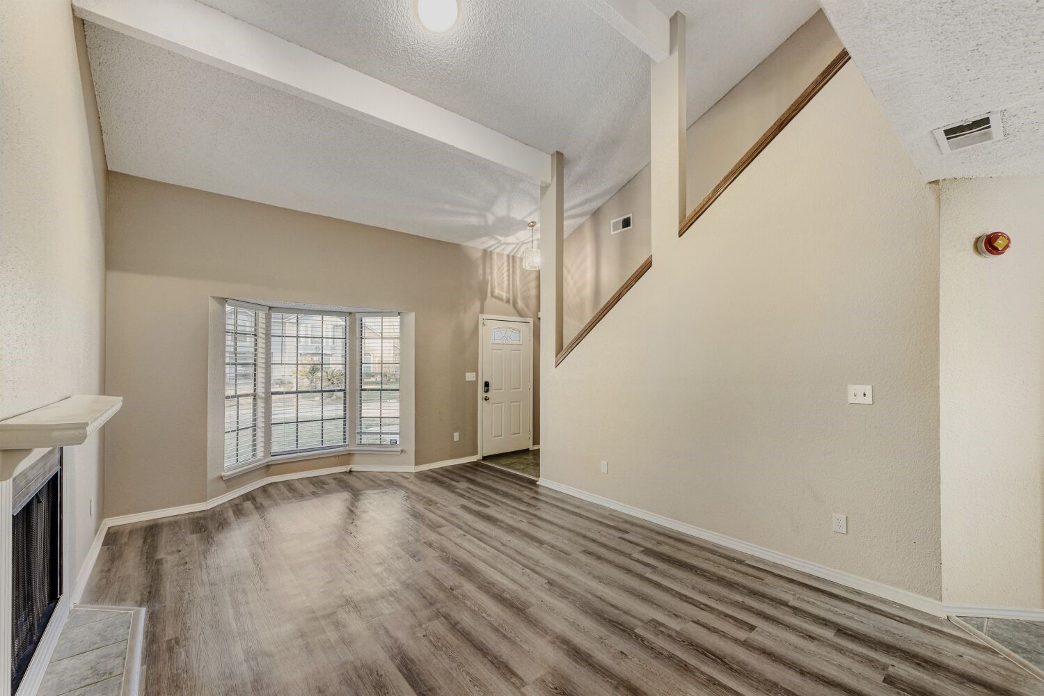 9727 Orangevale Drive Spring, TX 77379 - Photo 4 of 26 a view of an empty room with wooden floor and a window