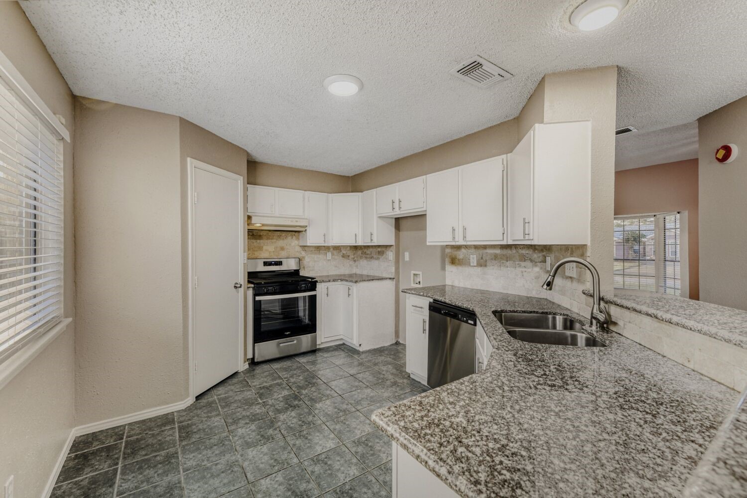 9727 Orangevale Drive Spring, TX 77379 - Photo 5 of 26 a kitchen with a stove a sink and a refrigerator