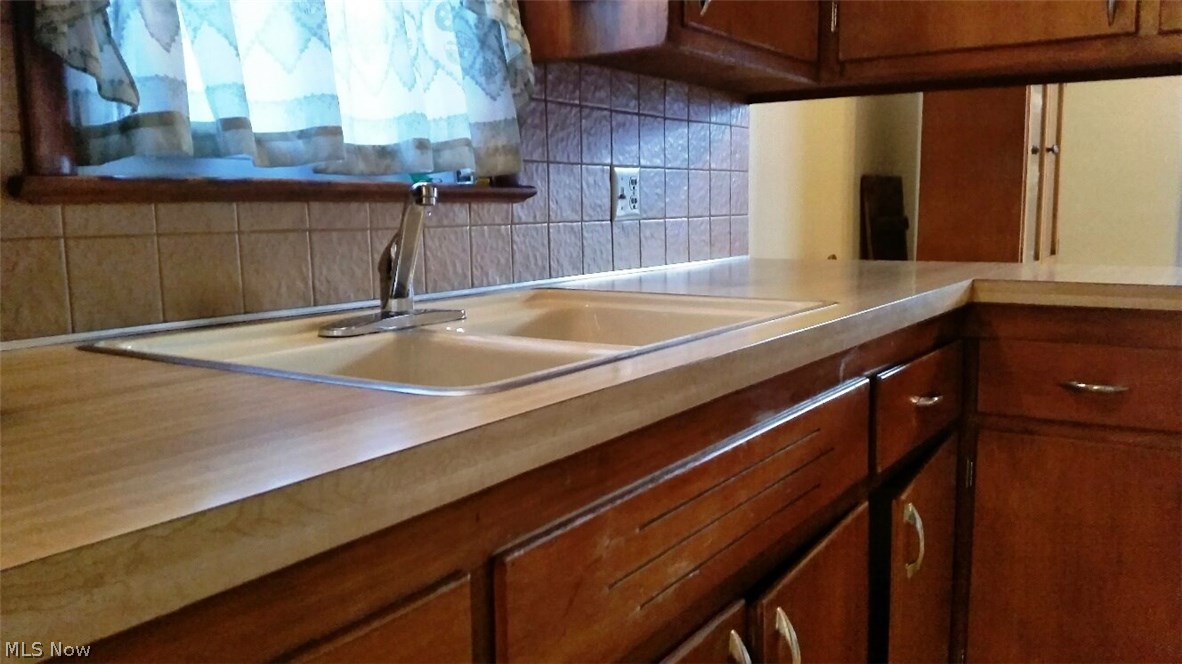 13271 McCracken Road Cleveland, OH 44125 - Photo 9 of 24 Well maintained countertop, sink and cabinets.