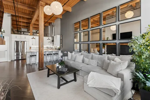 a living room with furniture a chandelier and pool table