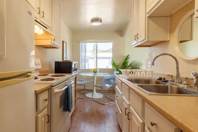 a kitchen with a sink and a stove top oven