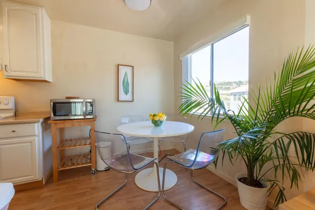 a dining room with furniture and window