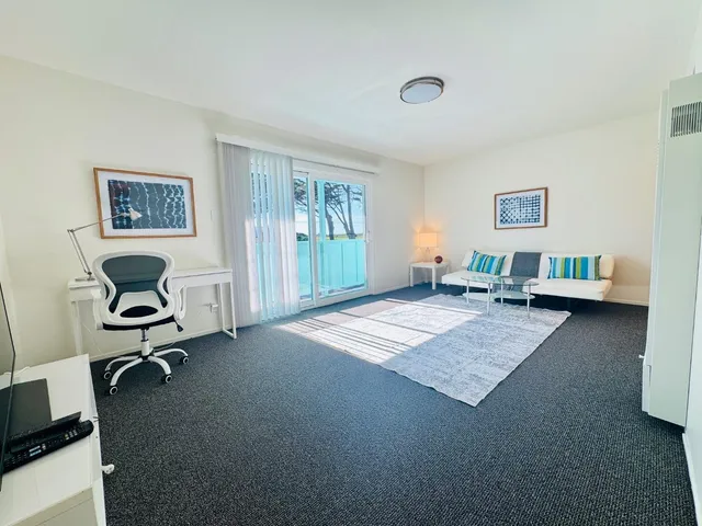 a bathroom with a white toilet sitting next to a bathroom sink and a bathtub