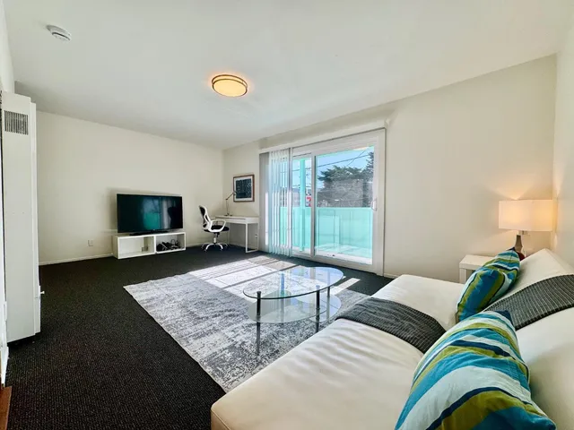 a kitchen with stainless steel appliances kitchen island granite countertop a stove top oven and sink