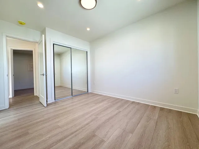 a kitchen with stainless steel appliances white cabinets and a stove top oven