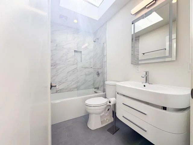 a bedroom with two beds and a chair