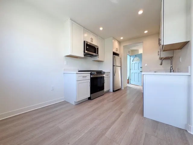 a view of a livingroom with furniture and a window
