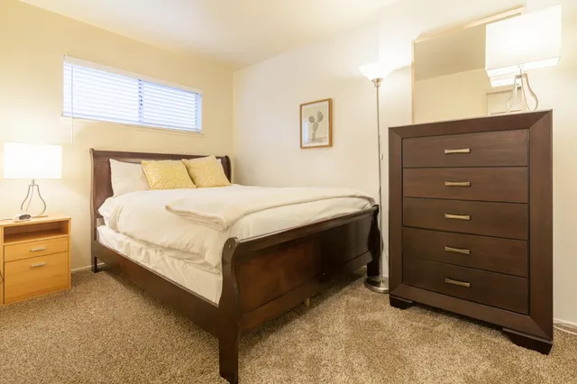 a bedroom with two beds and a window