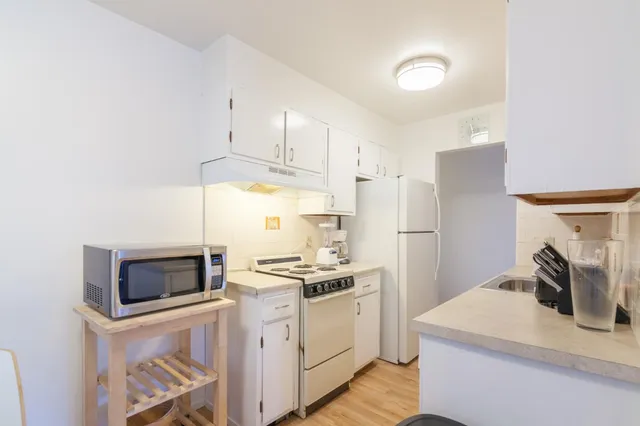 a bedroom with a bed and lamp