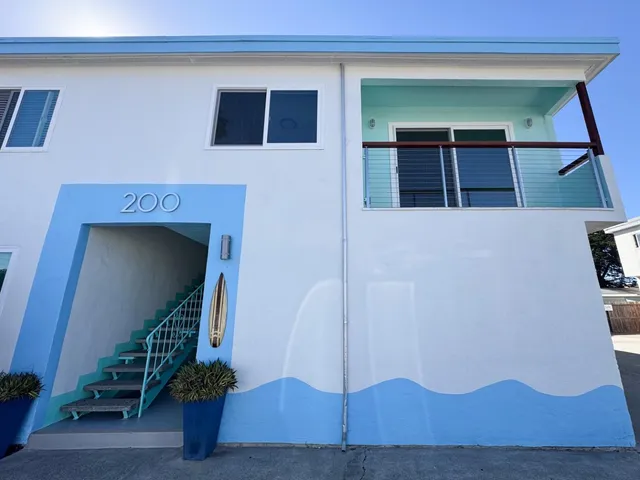 a work room with wooden floor and white cabinets