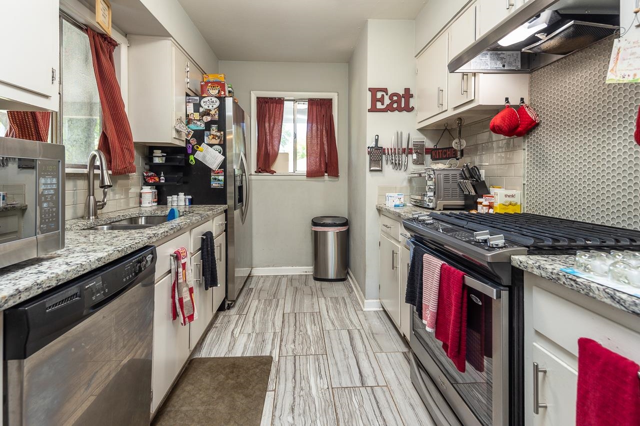 4560 Jamerson Road Memphis, TN 38122 - Photo 8 of 19 a kitchen with stainless steel appliances granite countertop a stove and a sink