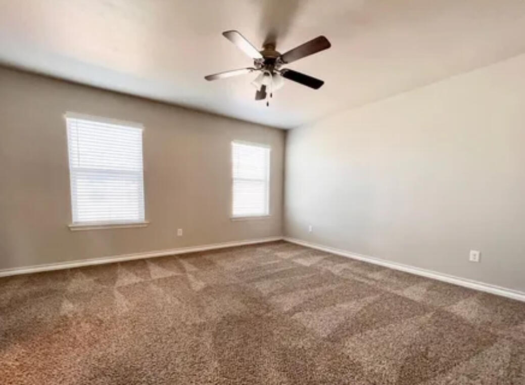 6040 24th Street, Unit 43 Lubbock, TX 79407 - Photo 6 of 11 an empty room with windows and fan