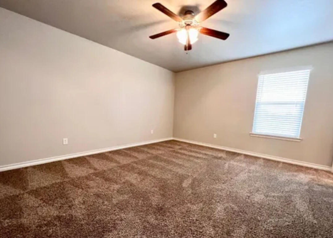6040 24th Street, Unit 43 Lubbock, TX 79407 - Photo 8 of 11 an empty room with windows and fan