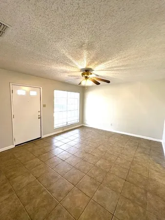 an empty room with a empty space and windows