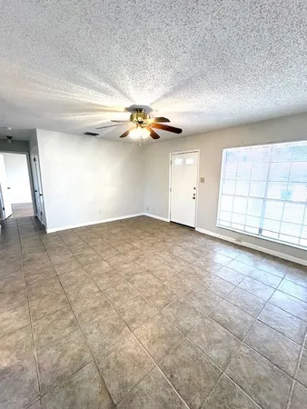 an empty room with a empty space and windows