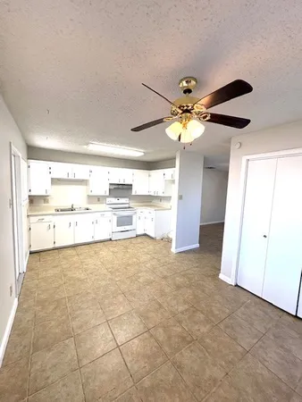 a view of a kitchen with a sink and a cabinet