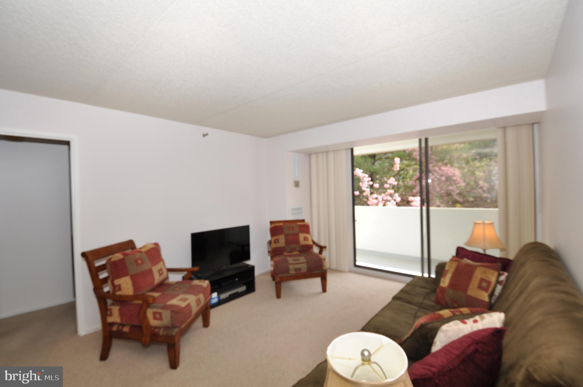 5911 Edsall Road, Unit 403 Alexandria, VA 22304 - Photo 9 of 29 a living room with furniture and a flat screen tv