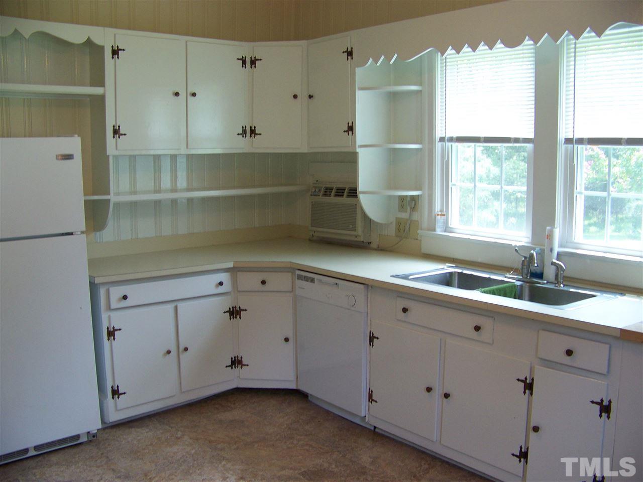 2114 Sanders Road Stem, NC 27581 - Photo 11 of 23 a room with white cabinets and a window