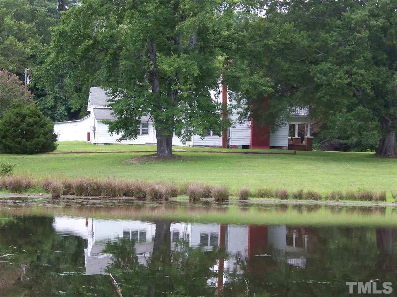 2114 Sanders Road Stem, NC 27581 - Photo 17 of 23 a view of a lake with a building and swimming pool