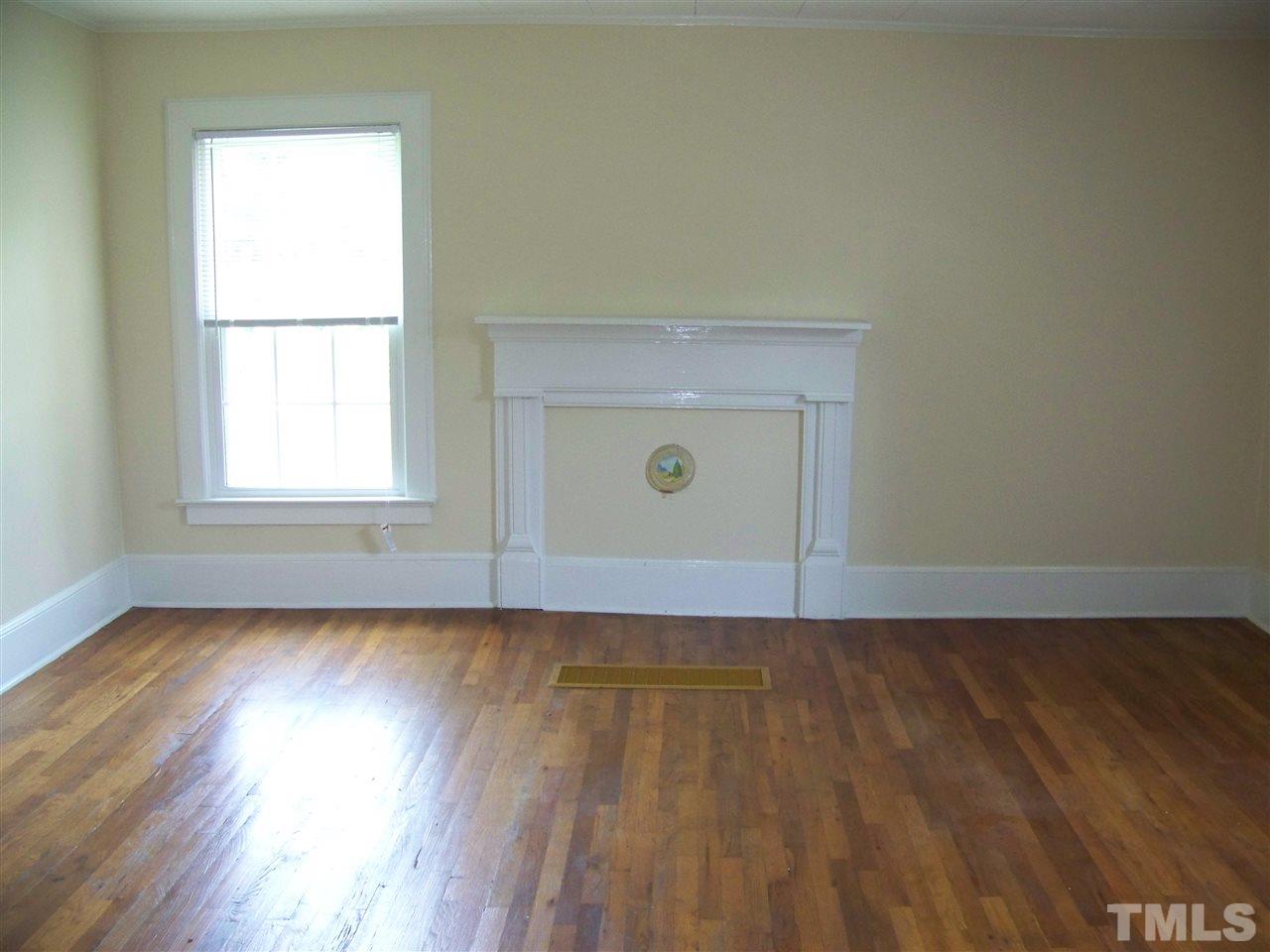 2114 Sanders Road Stem, NC 27581 - Photo 23 of 23 an empty room with wooden floor and windows