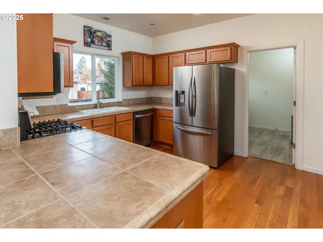 a kitchen with stainless steel appliances a refrigerator and a sink