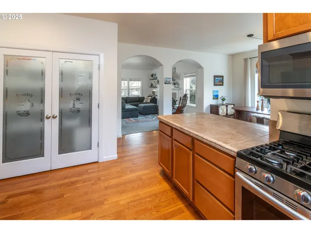 a kitchen with stainless steel appliances granite countertop a sink and a refrigerator