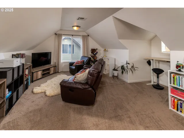 a bedroom with a bed a large mirror and a flat screen tv