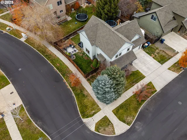 front view of a house with a small yard and potted plants