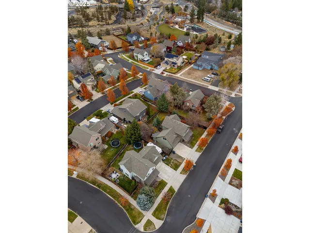 an aerial view of residential house with parking