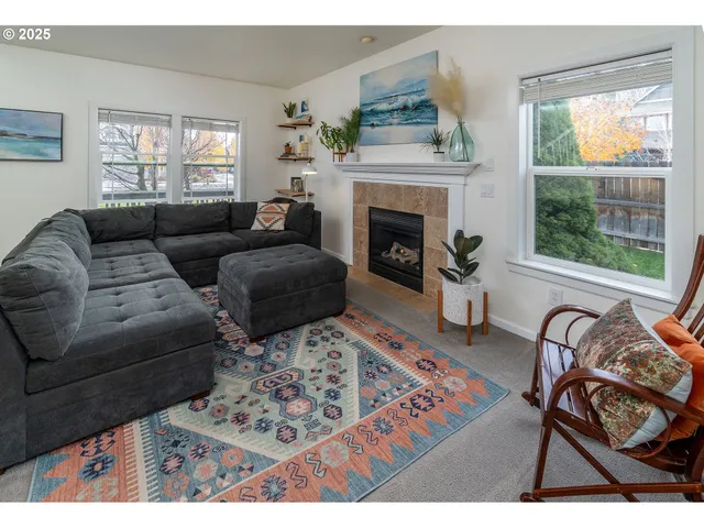 a living room with furniture and a fireplace