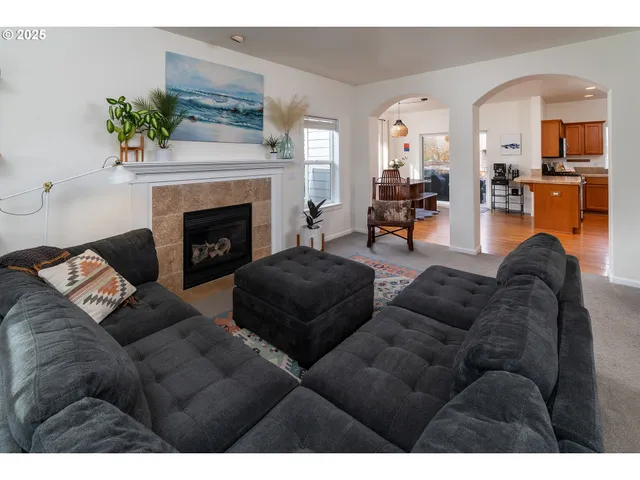 a living room with furniture and a fireplace