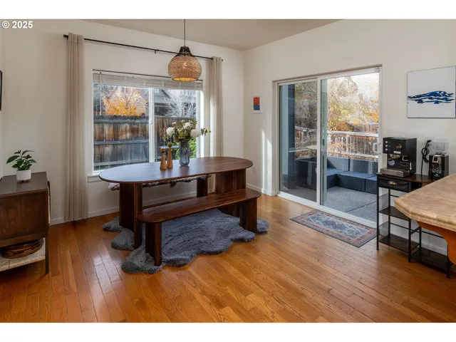 a living room with furniture a window and wooden floor